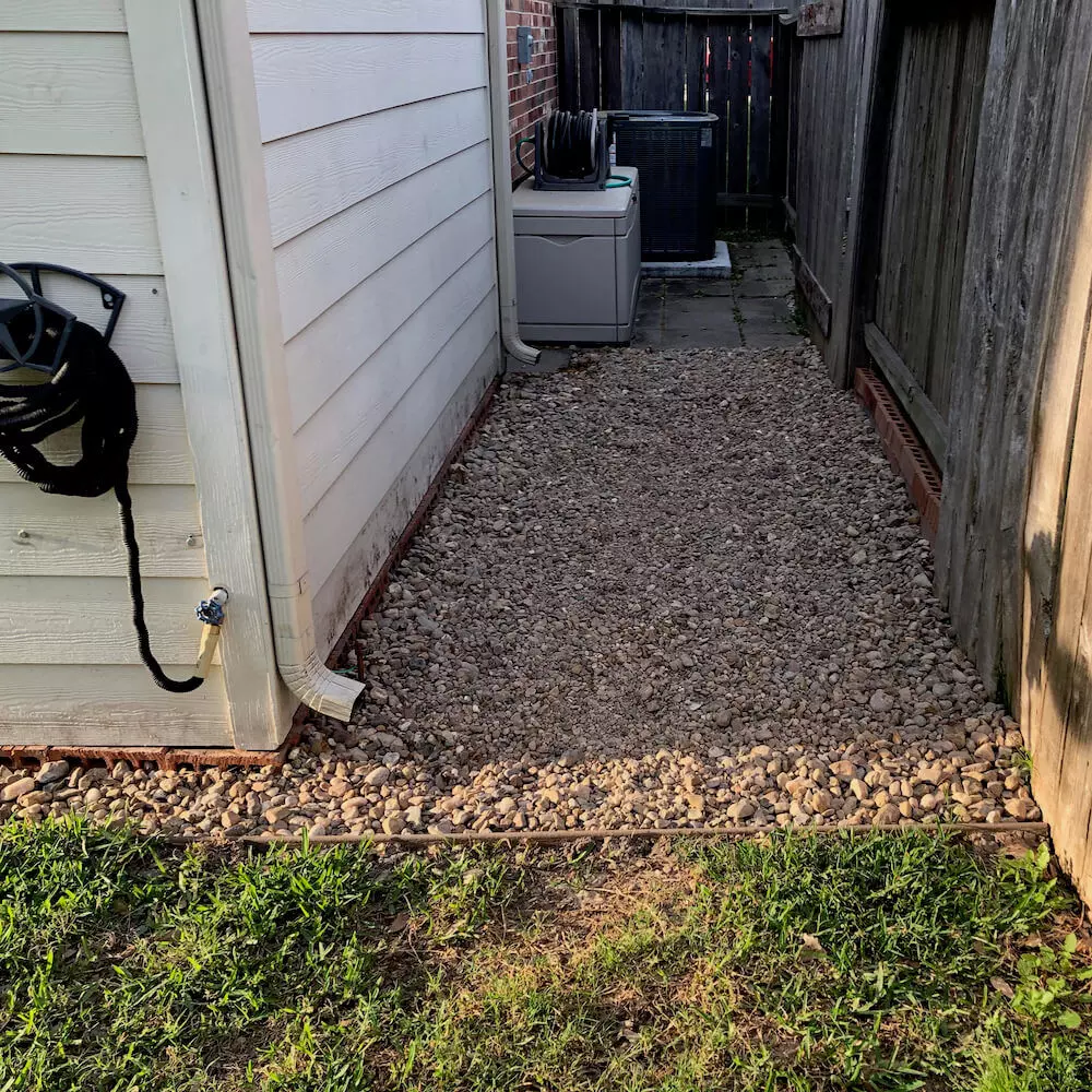 landscape drainage back yard river rock